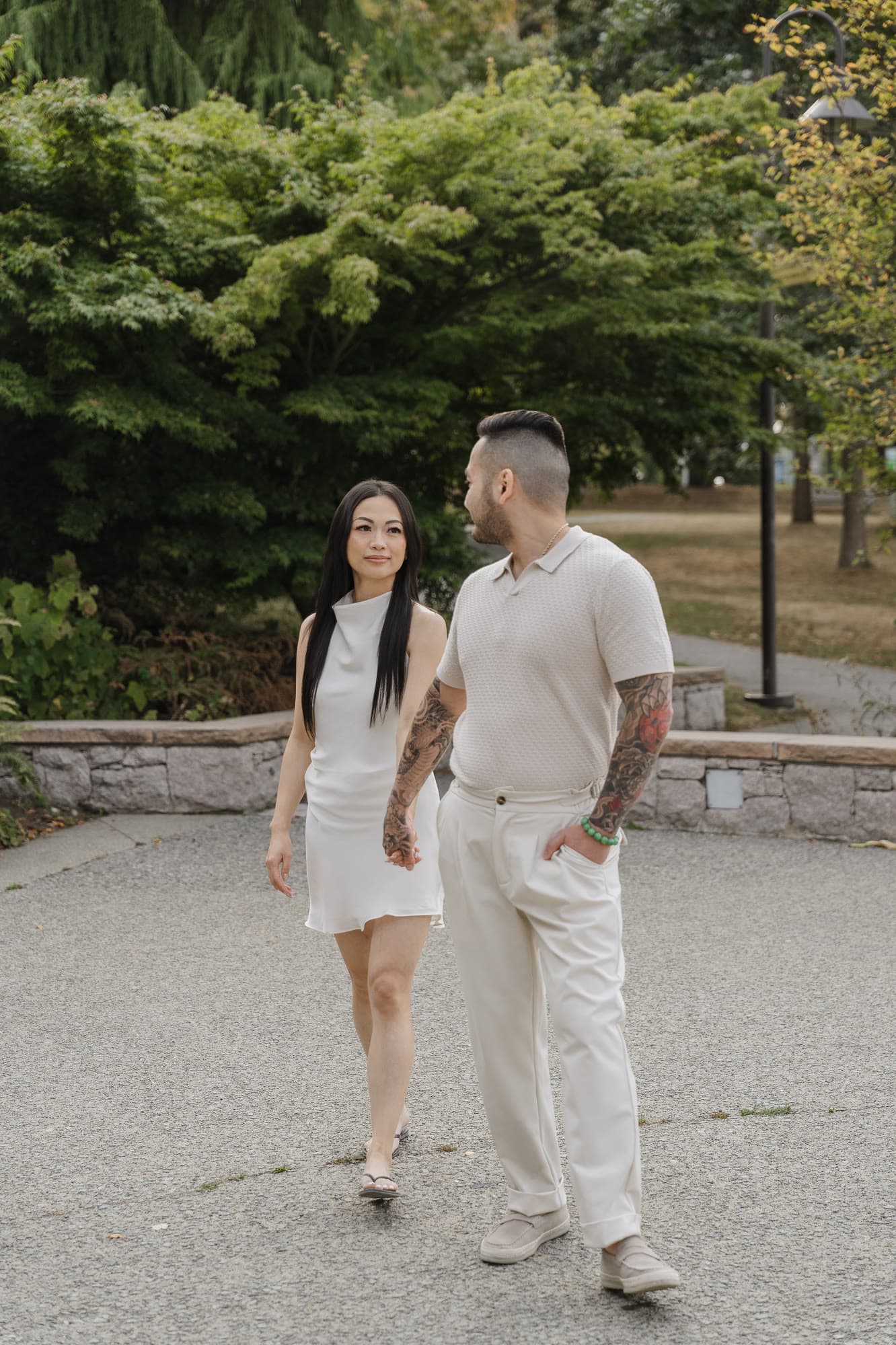 Alana and Colin walking together along a park path.