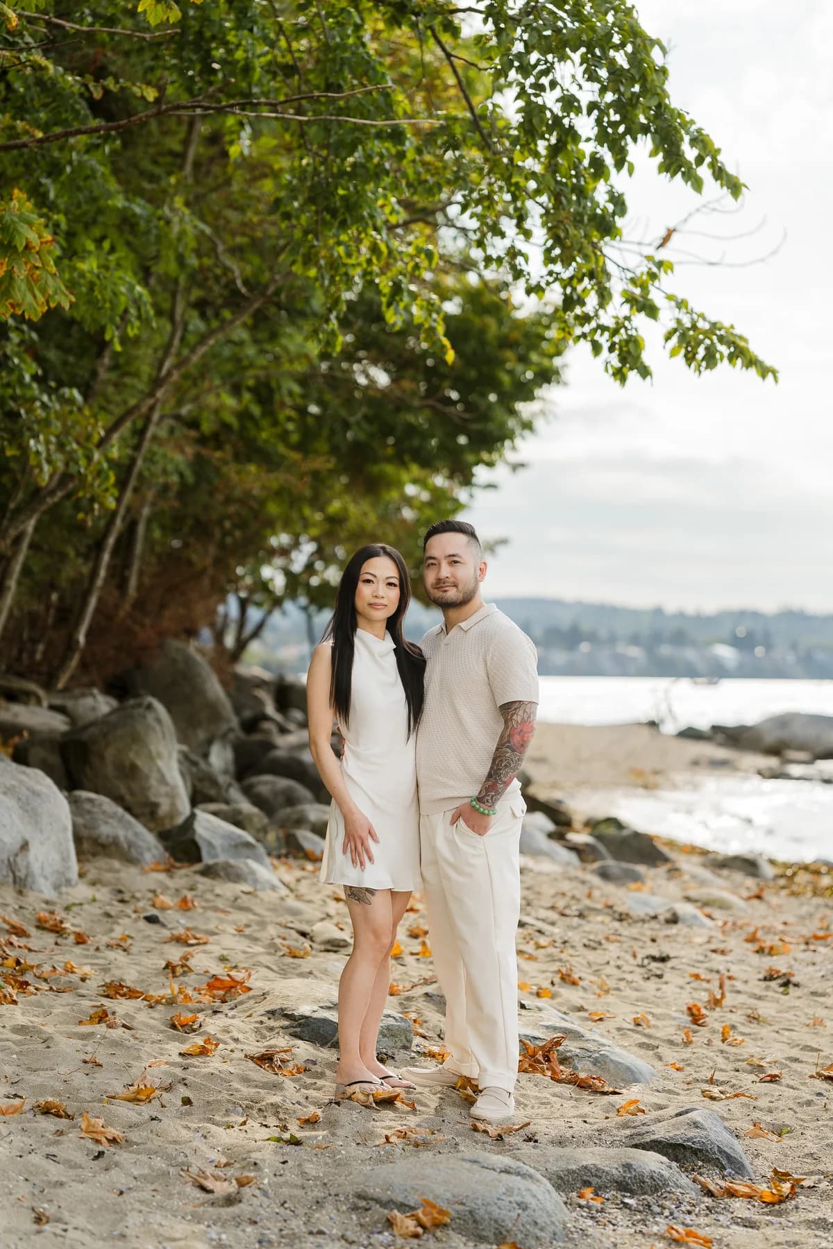 Alana and Colin standing together on a rocky beach.