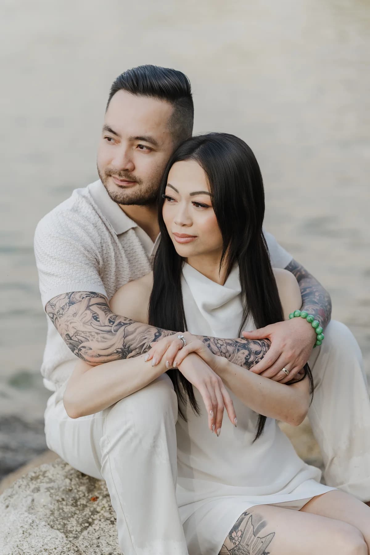 Alana and Colin embracing by the water.