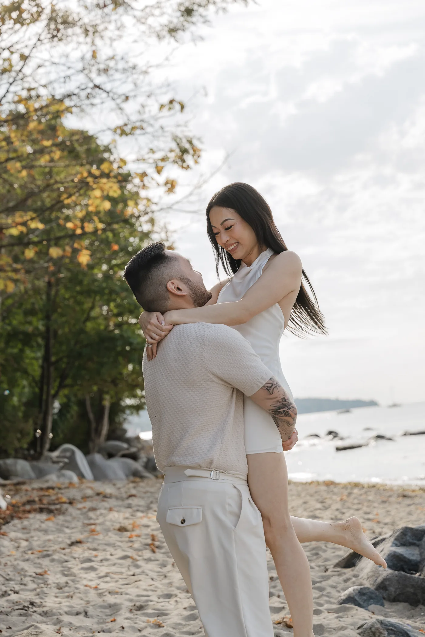 Alana smiling at Colin as he lifts her into an embrace.