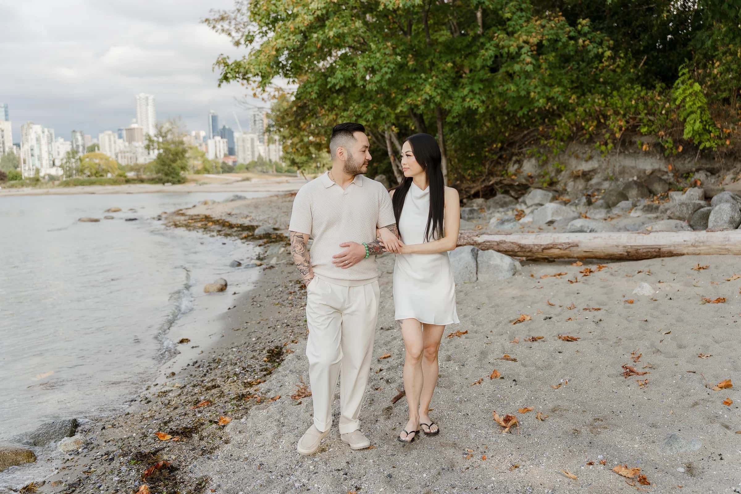 Alana and Colin together on a tree-lined shore.